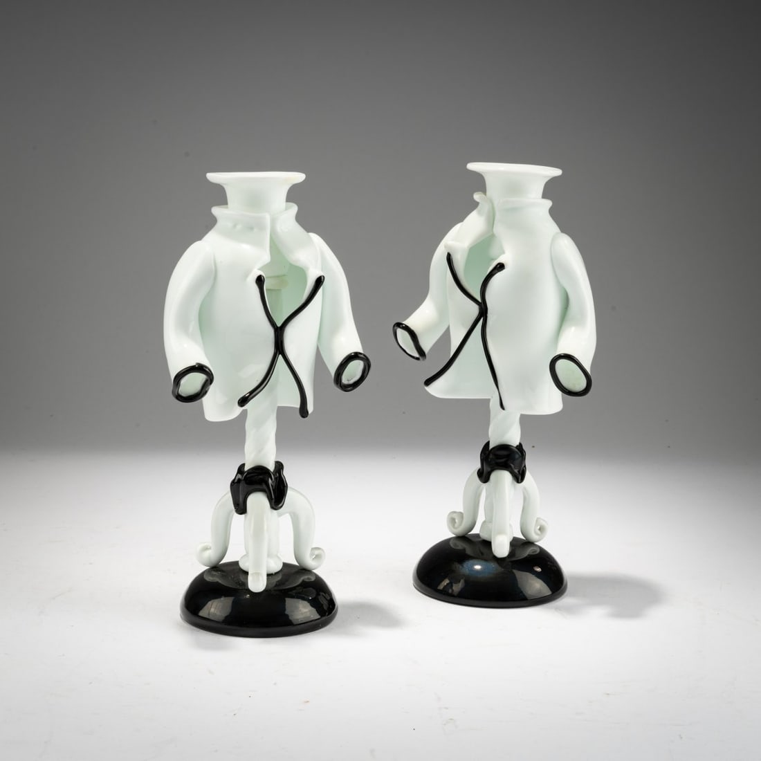 Fulvio Bianconi, A pair of candlesticks from the 'Commedia dell'Arte' series,: <p>Model No. 2913. H: 22.5 cm. Execution: Venini. Black and white iridescent glass. Each piece is marked: venini murano MADE IN ITALY (acid stamp).