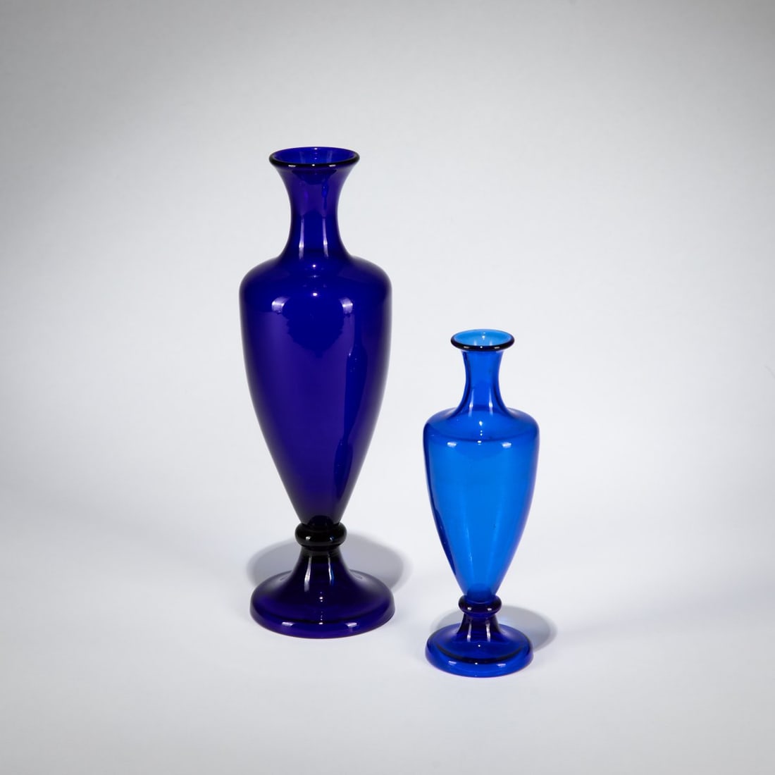 Come on, Two vases, c. 1950: <p>H. 17.5 or 25 cm. Blue glass. Each marked: venini murano ITALIA (acid stamp).</p>