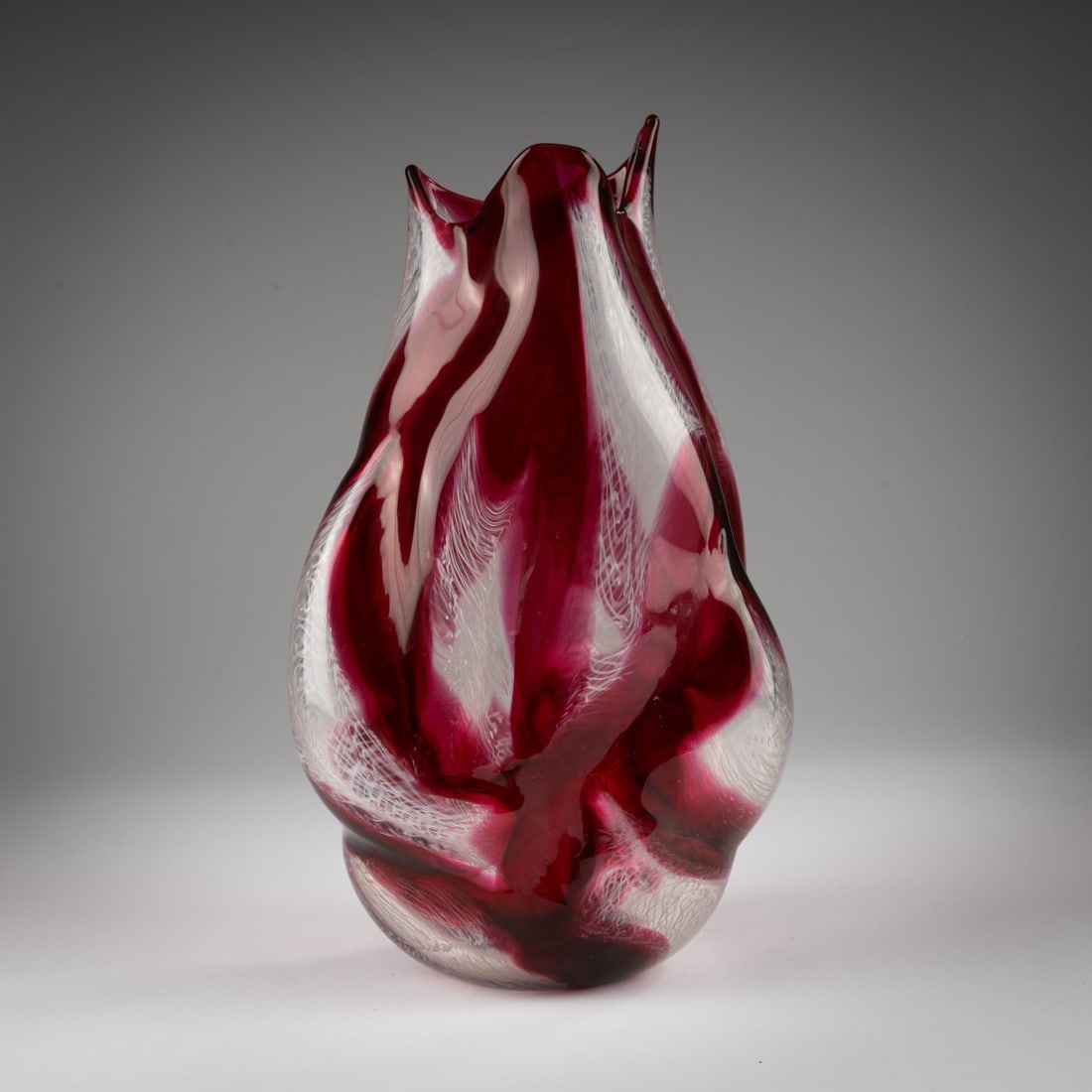 Archimede Seguso, 'Merletto irregolare' vase, 1953: <p>Irregular, multiply indented body, rim raised three times. H. 39 cm. Execution: Archimede Seguso. Cased glass, colorless, partially fused bands with white 'Merletto'