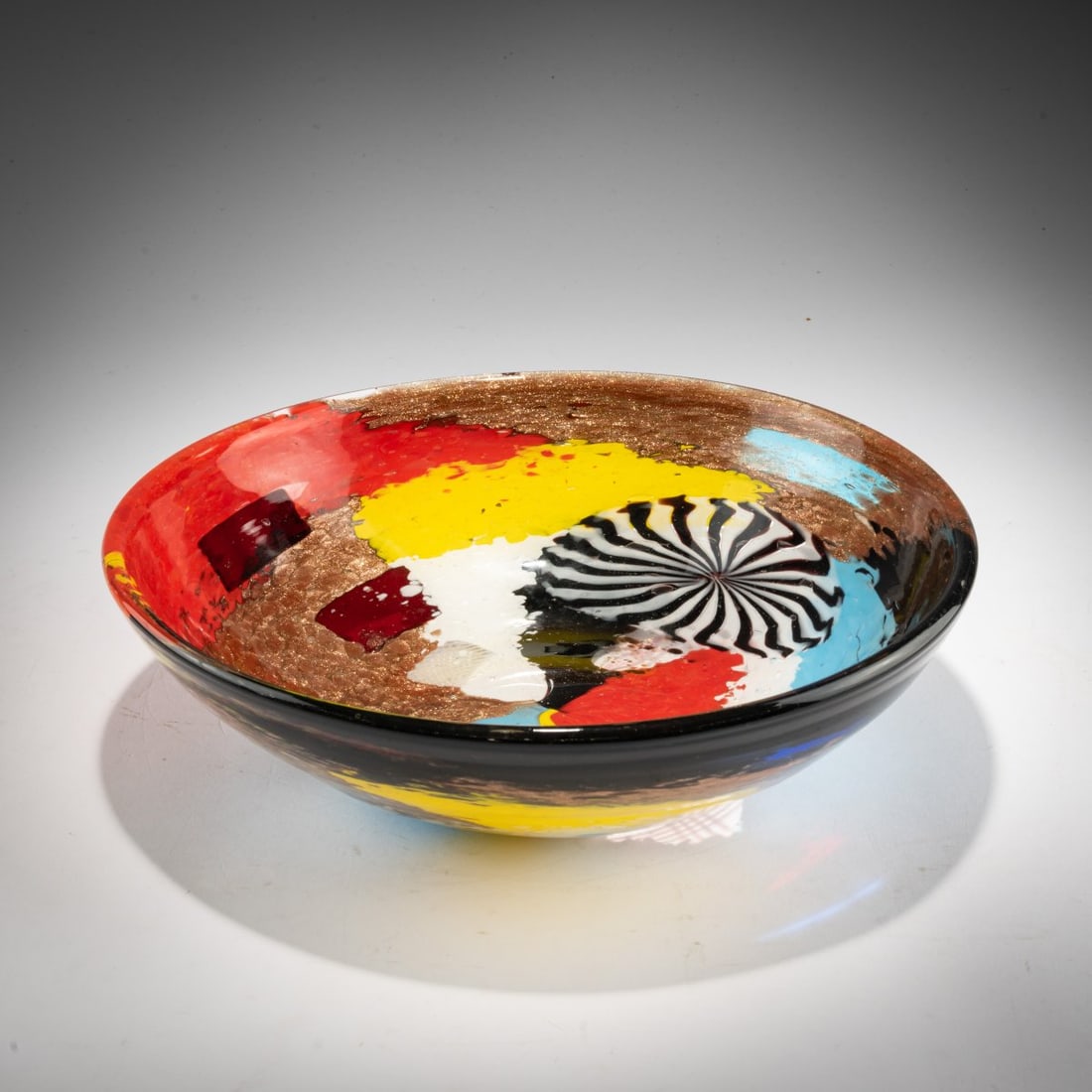 Dino Martens, Large 'Oriente' bowl, c. 1954: <p>H. 8.5 cm; &Oslash; 29.5 cm. Execution: Aureliano Toso. Cased glass, colorless with multicolored powder inclusions, rectangular platelets with differently colored underlays, thread-like