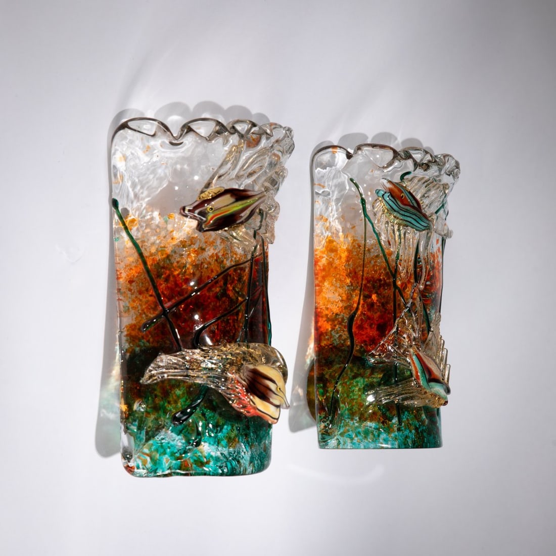Cenedese, Two wall sconces, c. 1960: <p>H. 21 cm; 15 x 10.5 cm. Clear glass block with polychrome fusing techniques; brass mounting.</p>