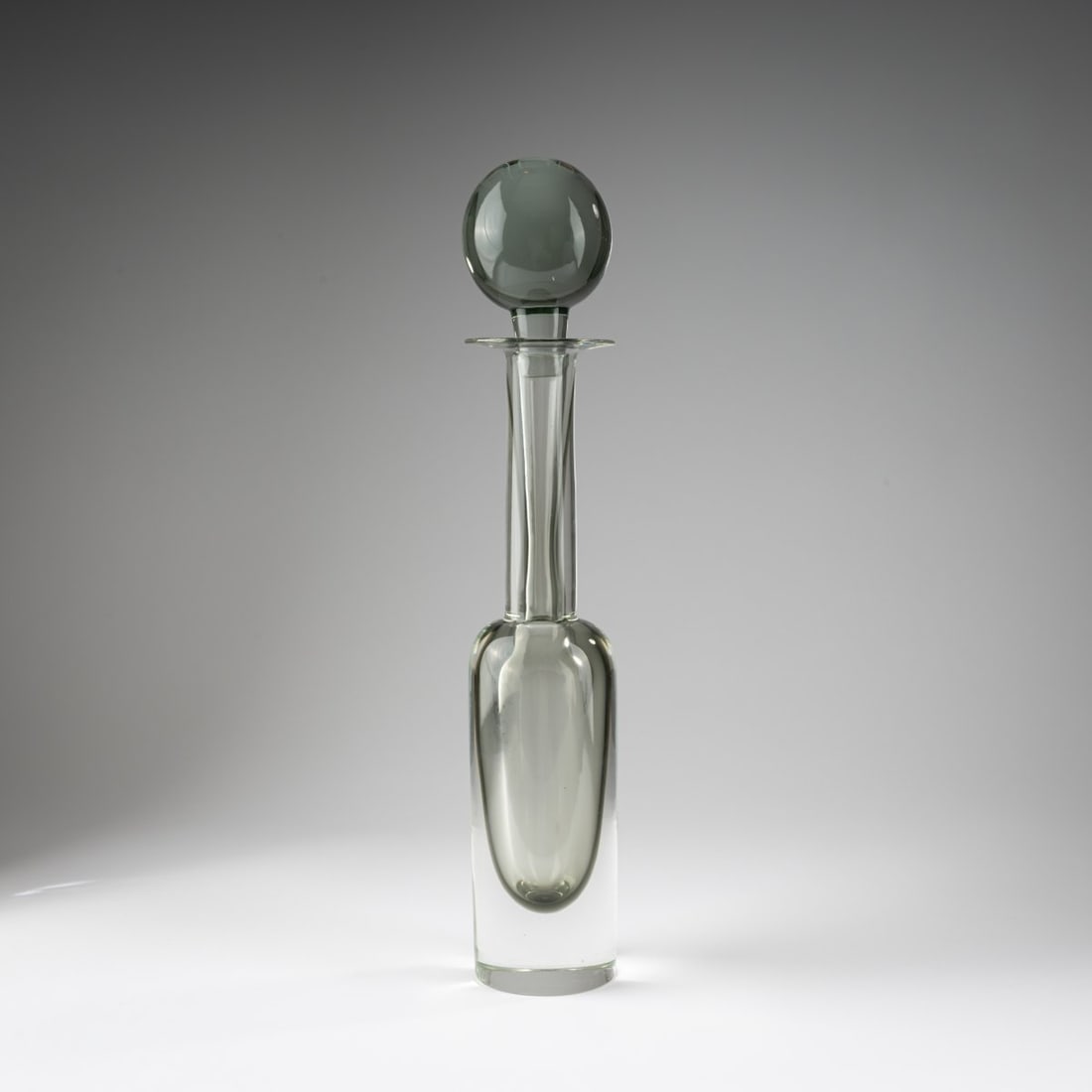 Mario Pinzoni, 'Sommerso' bottle with stopper, 1962–1969: <p>H. 51.5 cm. Execution: Seguso Vetri d'Arte. Thick cased glass, colorless and gray. </p>