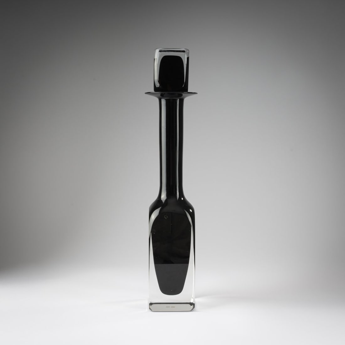 Mario Pinzoni, 'Sommerso' bottle with stopper, c. 1970: <p>Model-No 13522. H. 54 cm. Bottle with a square base. Execution: Seguso Vetri d'Arte. Cased glass, colorless and dark gray. </p><hr><p>Literature:</p><p>