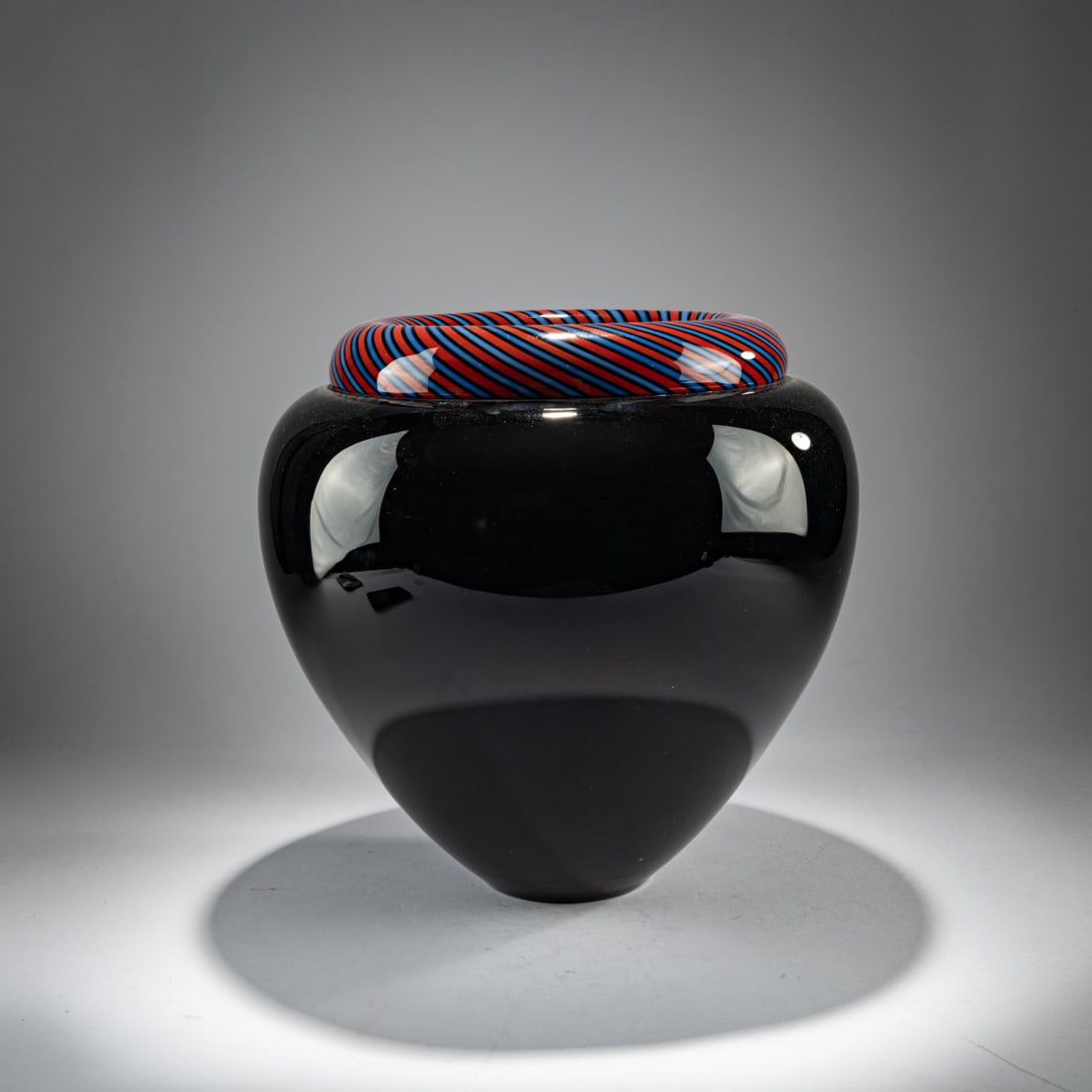 Lino Tagliapietra, Vase, 1984: <p>H. 30 cm. Execution: Effetre International. Cased glass, colorless and black, with fused bands in black, blue, and red. Marked: Lino Tagliapietra murano 1984 (diamond-cut).</p><hr>