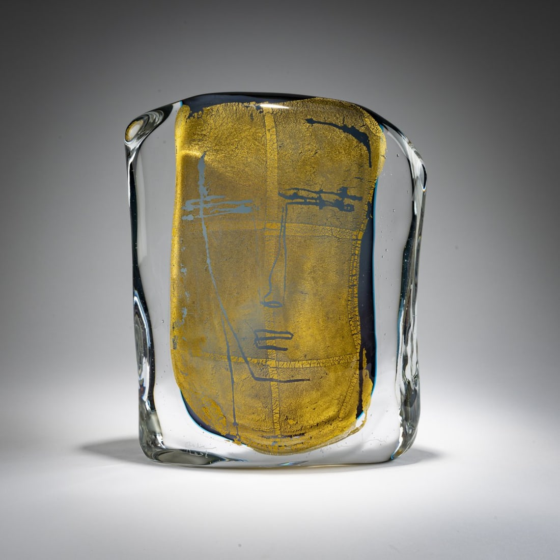 Luigi Benzoni, Glass sculpture 'Beatus Vir', 2008: <p>H. 32 cm; 25 x 5 cm. Glass block with a gray-blue fusion and finely burst gold foil depicting facial features. Marked: Benzoni Murano 2008 (engraved). </p>