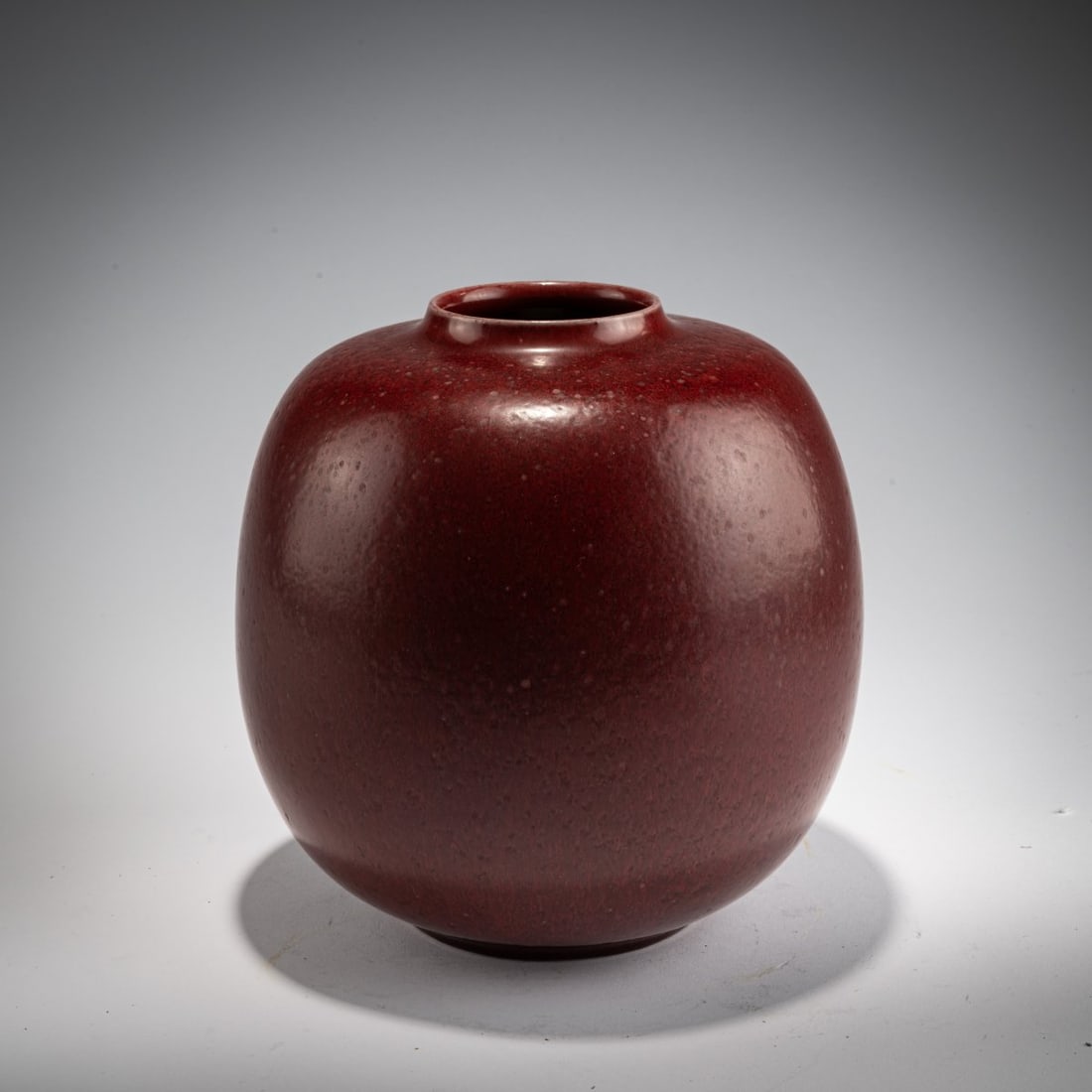 Kresten Bloch , Vase, 1963: <p>H. 21 cm. <br />KPM, Copenhagen.<br />Stoneware, oxblood-red high-fire glaze. <br />Marked: ROYAL COPENHAGEN DENMARK (green), waves, artist&rsquo;s signature KB (blue), 