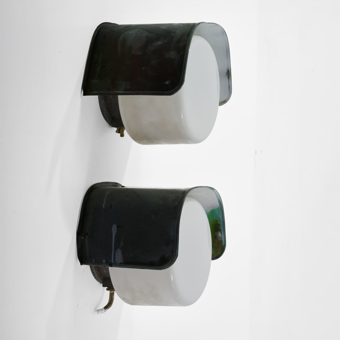 Idman Oy, Vilhonvuorenkatu, Two wall lights, 1950s (design): <p>H. 27.5 x 31 x 24 cm.<br />Sheet metal painted white and dark green, cast metal, white glass.</p>