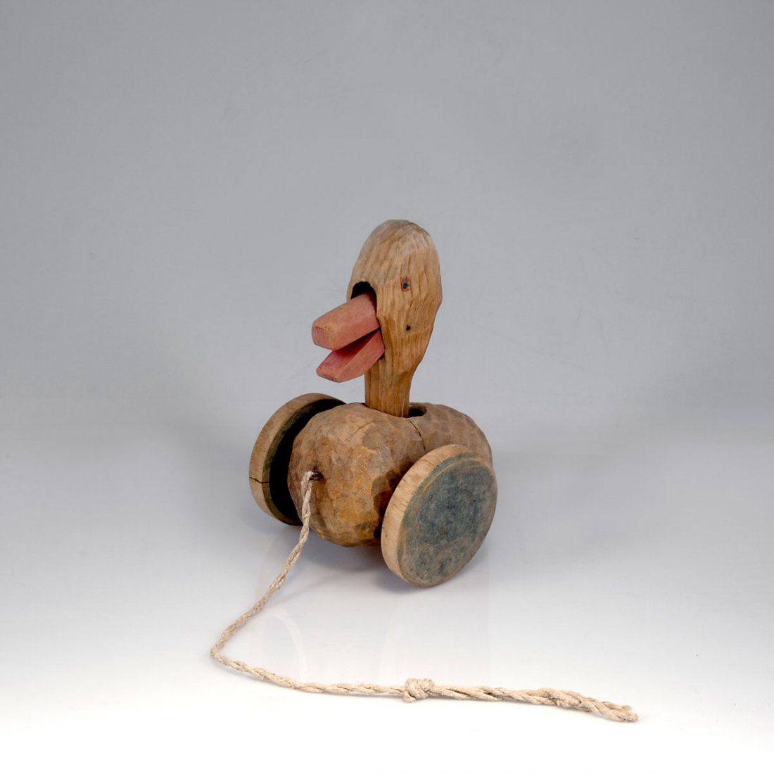 Toys: Duck, bear and hare: Waldorf school. Pull toys, duck, bear and hare, 1929/30. H. 25 cm (max.); H. 8-10.8 cm. Carved soft wood, turned wheels, residue of red and green paint, cord. Bear and hare marked: DORNACH.