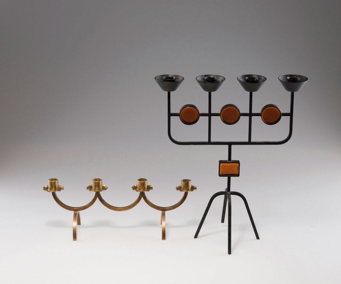 Two candlesticks: Gunnar Ander. Two candlesticks, 1950s. H. 33 cm; L. 28.3 cm; H. 11 cm; L. 31 cm. Made by Ystad Metall. Metal, painted black, amber glass respectively brass rods, sheet brass.