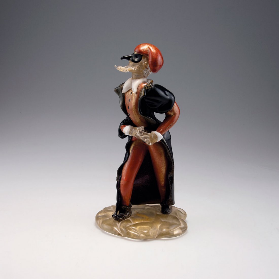 'Pantalone' from the 'Commedia dell'Arte: Gino Cenedese. 'Pantalone' from the 'Commedia dell'Arte, 1950s. H. 28.7 cm. Cased glass, clear, red, black and white, burst gold foil.
