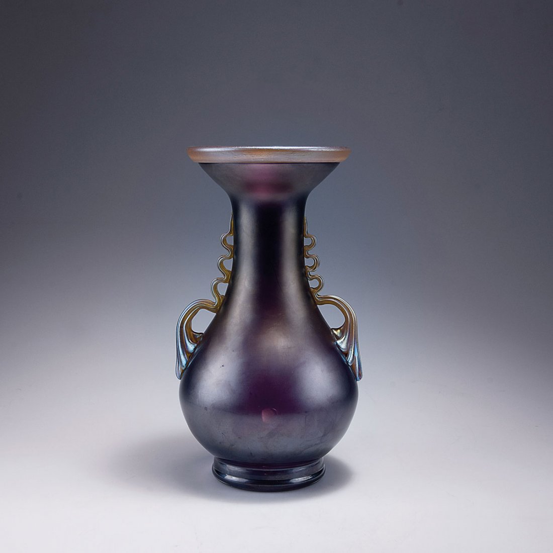 Loetz Wwe., Klostermuhle. Large vase with handles,: Loetz Wwe., Klostermuhle. Large vase with handles, c1905-07. H. 30.6 cm. Cased glass, clear and purple, matt mother of pearl lustre. Applied rim and handles with silver yellow fusions.