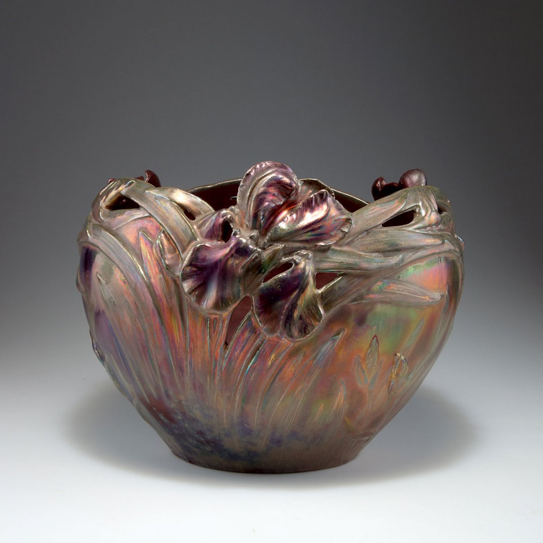 Delphin Massier, Vallauris. Flowerpot with iris, c1890.: Delphin Massier, Vallauris. Flowerpot with iris, c1890. H. 24.5 cm; D. 33 cm. Faience, lustre glaze, dark red, green and gold, reliefed pattern with iris. Marked: DELPHIN MASSIER VALLAURIS AM.