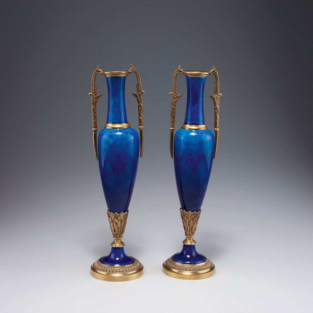 Paul Milet, Sevres. Pair of candlesticks, c1920. H.: Paul Milet, Sevres. Pair of candlesticks, c1920. H. 35.8-36 cm. Faience, glazed dark blue on white, gilt bronze mounting.