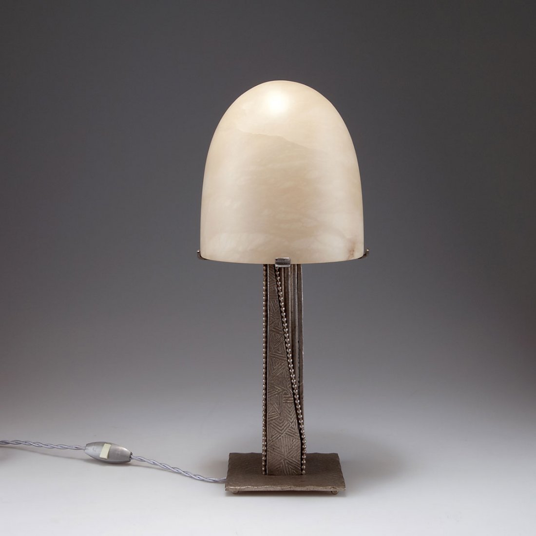 France. Table light, c1930. H. 41.3 cm; D. 17.5 cm.: France. Table light, c1930. H. 41.3 cm; D. 17.5 cm. Wrought-iron, silver patina. Alabaster shade.