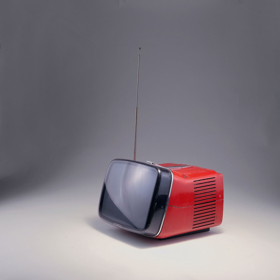 Marco Zanuso; Richard Sapper. 'Algol 11' TV-set, 1964.: Marco Zanuso; Richard Sapper. 'Algol 11' TV-set, 1964. H. 22.4 x 26 x 30.5 cm. Made by Brionvega, Milan. Red plastic, smoke black perspex. Marked: BRIONVEGA, algol 11''.