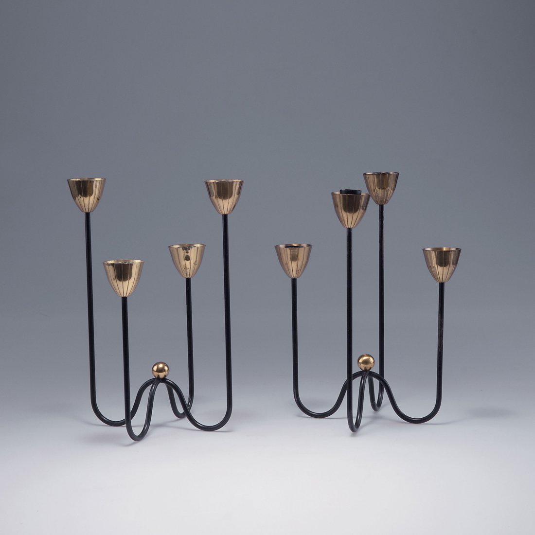 Gunnar Ander. Pair of candlesticks, c1960. H. 27.8 cm;: Gunnar Ander. Pair of candlesticks, c1960. H. 27.8 cm; D. 20.8-21 cm. Made by Ystad Metall, Ystad. Metal rods, painted black, brass.