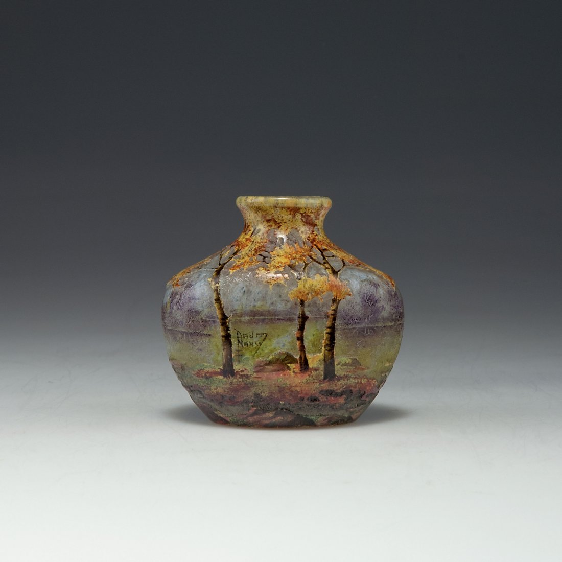 'Automne' vase: Daum Freres, Nancy. 'Automne' vase, 1905-10. H. 6.8 cm. Cased glass, clear, white, yellow/green and blue/purple powder inclusions. Matted and enamelled pattern. Heath landscape. Signed: DAUM NANCY, cr