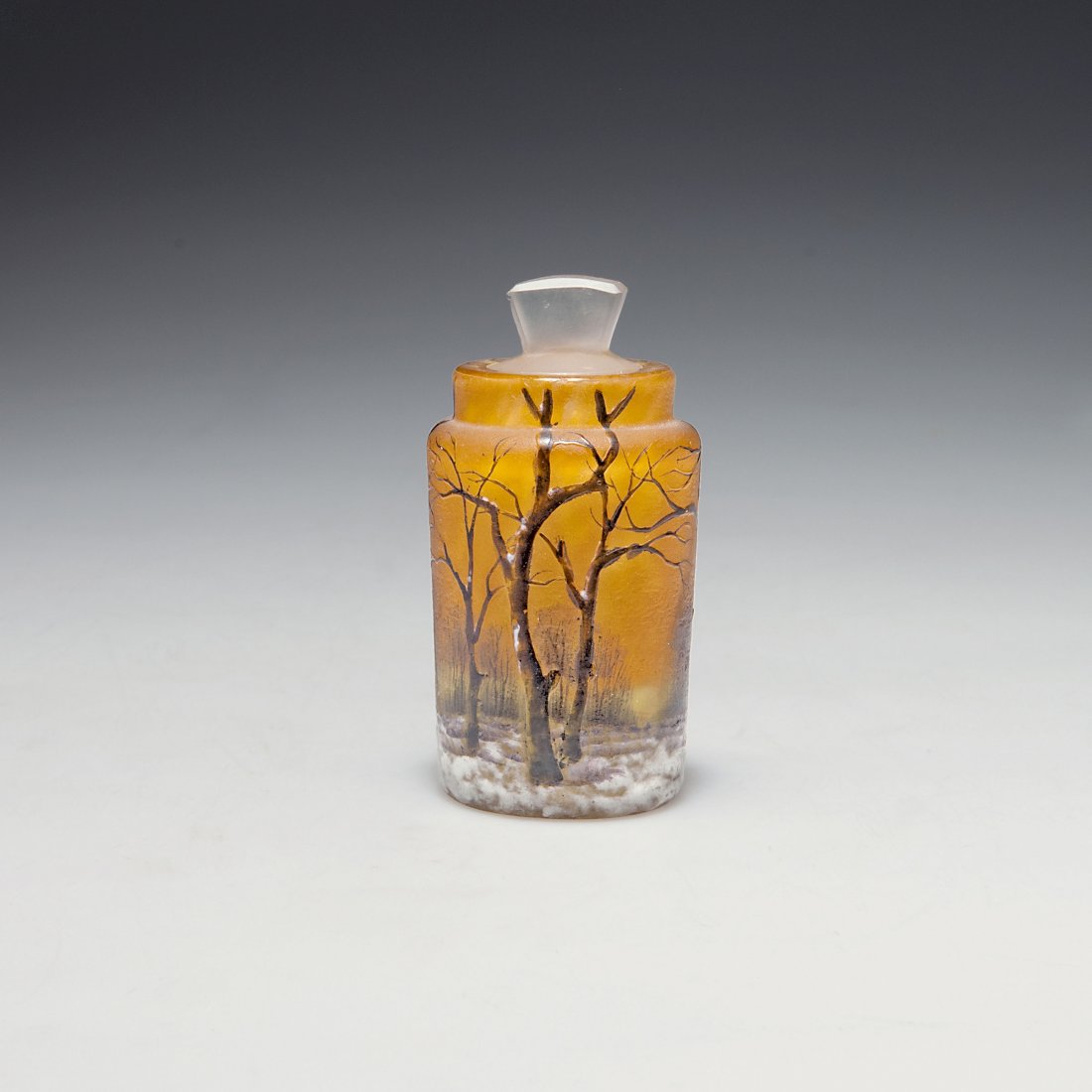 Small 'Arbres en hiver' flacon: Daum Freres, Nancy. Small 'Arbres en hiver' flacon, c1910. H. 7.5 cm. Cased glass, clear, lemon yellow and orange powder inclusions. Etched pattern, Grisaille paint and enamelled pattern. Winter lands