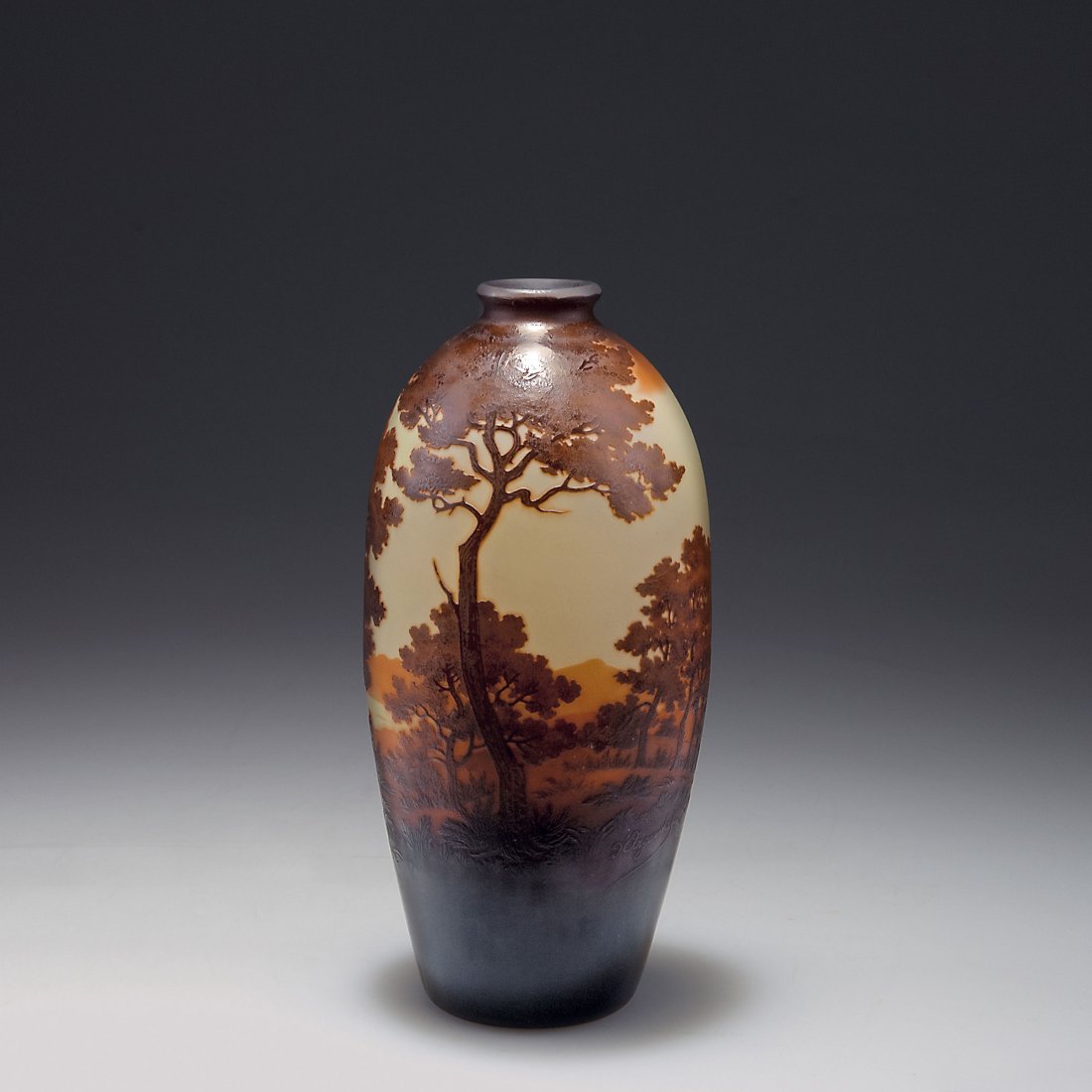 'Paysage' vase: Paul Nicolas, Nancy. 'Paysage' vase, 1919-24. H. 19.6 cm. Cased glass, clear, orange and brown. Multiply etched pattern with lake and trees. Signed: d'Argental.