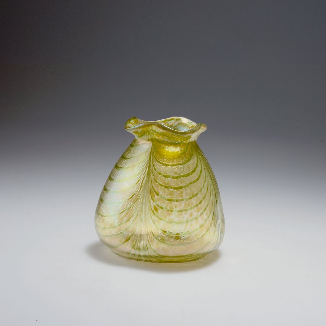 Vase: Bohemia. Vase, c1900. H. 13.9 cm. Clear glass, combed green threads, silver yellow crushed glass, matt mother of pearl lustre.