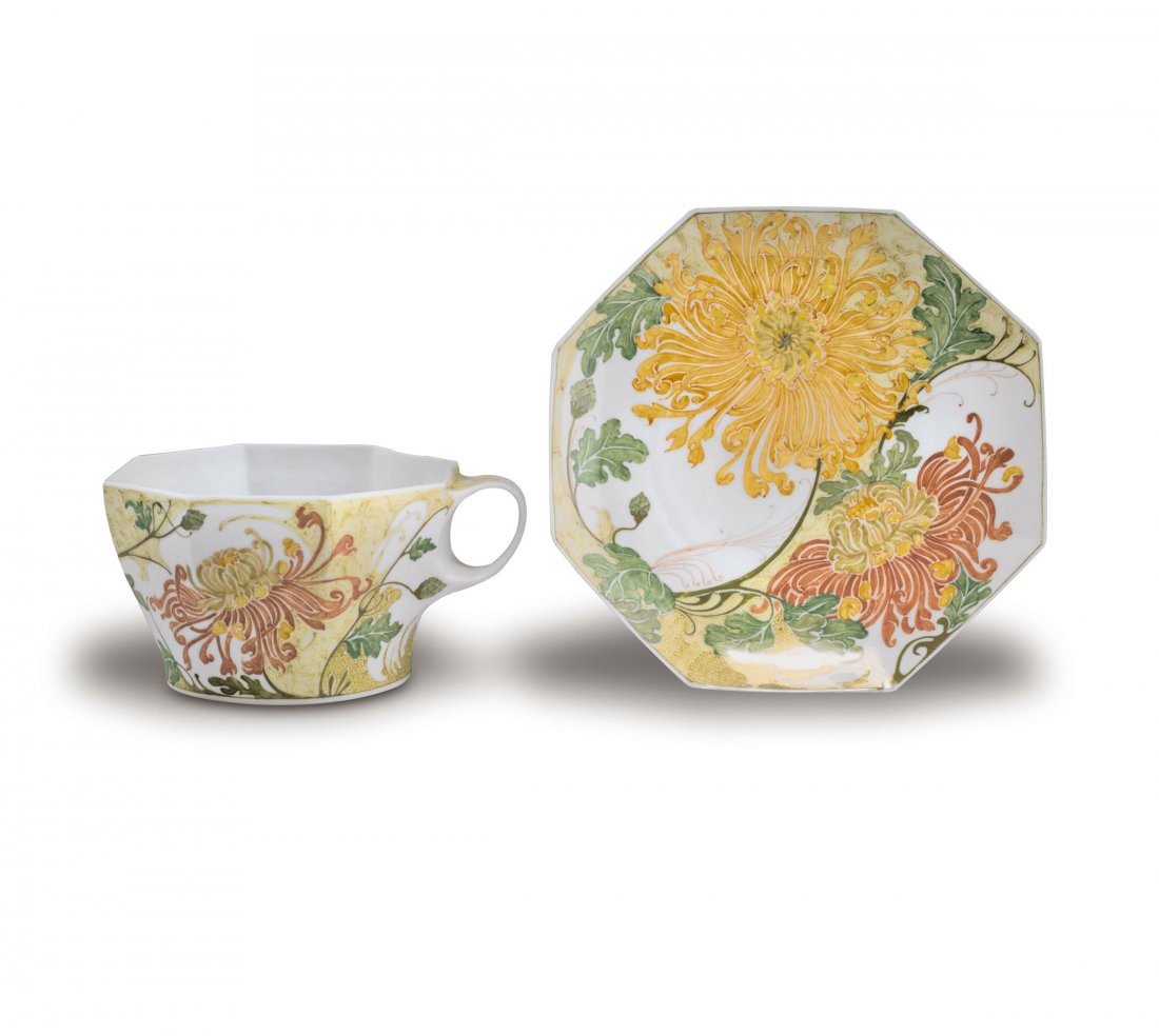 Tall cup and saucer: Samuel Schellink. Haagsche Plateelbakkerij Rozenburg. Large cup and saucer, 1914. H. 6.7 cm; D. 16.2 cm. Eggshell porcelain, white. Glazed green, yellow and red brown. Chrysanthemum. Marked: Stork, cr