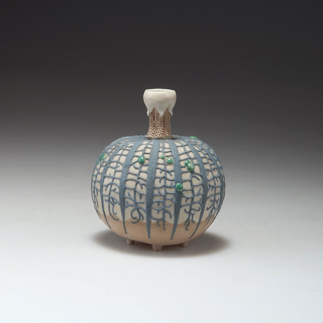 Small vase: Taxile Maximin Doat, Sevres. Small vase, c1920. H. 10.5 cm. Porcelain, reliefed, glazed matt grey, brown and dove blue. Green enamel dots. Illegibly signed. Collection no. 12-50.