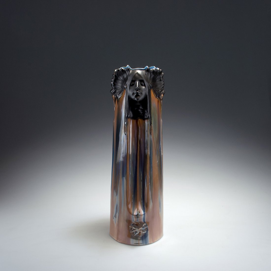 'Women's heads' vase: Bohemia. 'Women's heads' vase, c1900. H. 42 cm. Earthenware, beige-golden lustre glaze and matt anthracite. Marked: 9019.