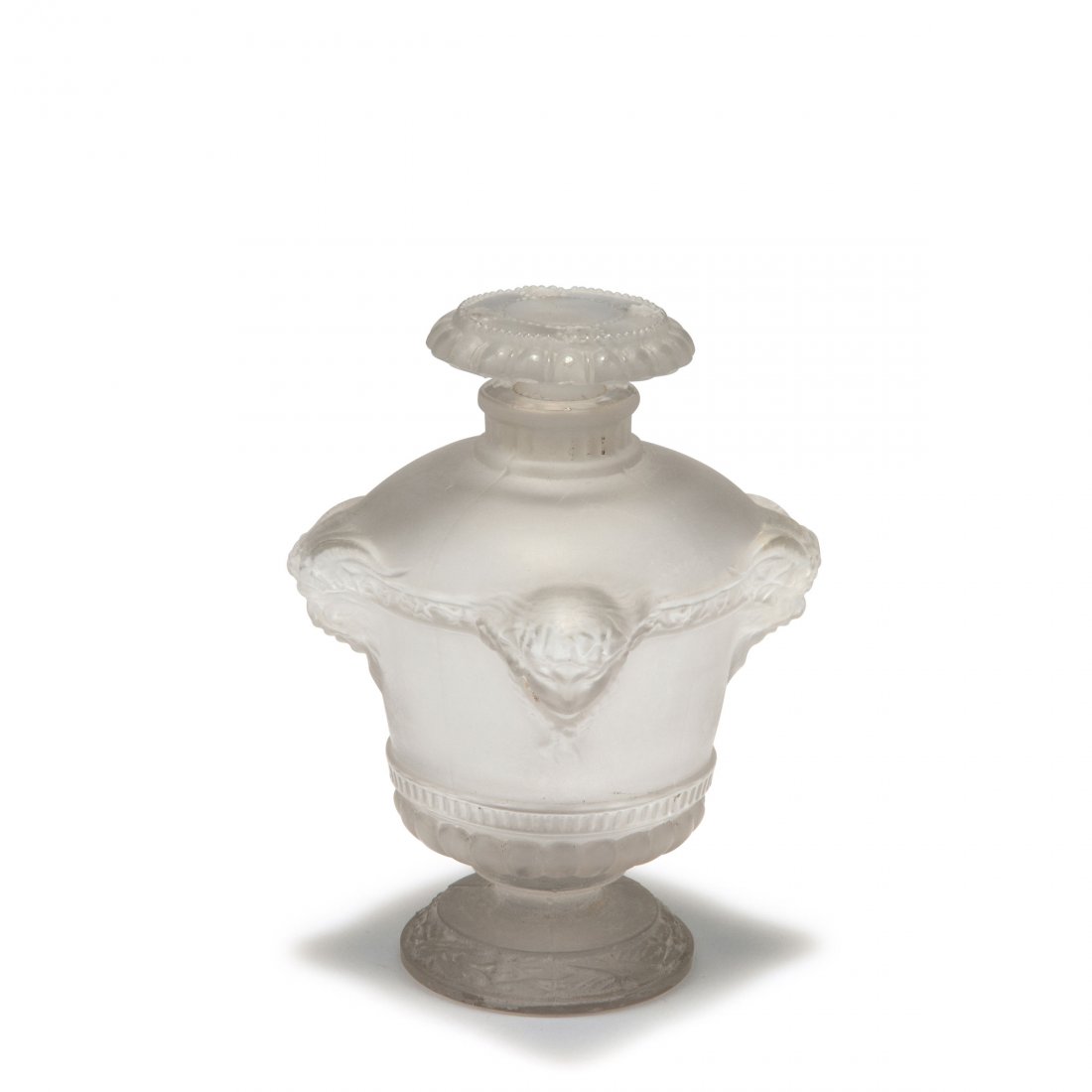 'Bouquet de faunes' flacon for Guerlain, 1925: Rene Lalique, Wingen-sur-Moder. 'Bouquet de faunes' flacon for Guerlain, 1925. H. 9.8 cm. Moulded clear glass, four reliefed faun's heads, matted. Marked: GUERLAIN PARIS, inscribed: 738, 4 (diamond cu
