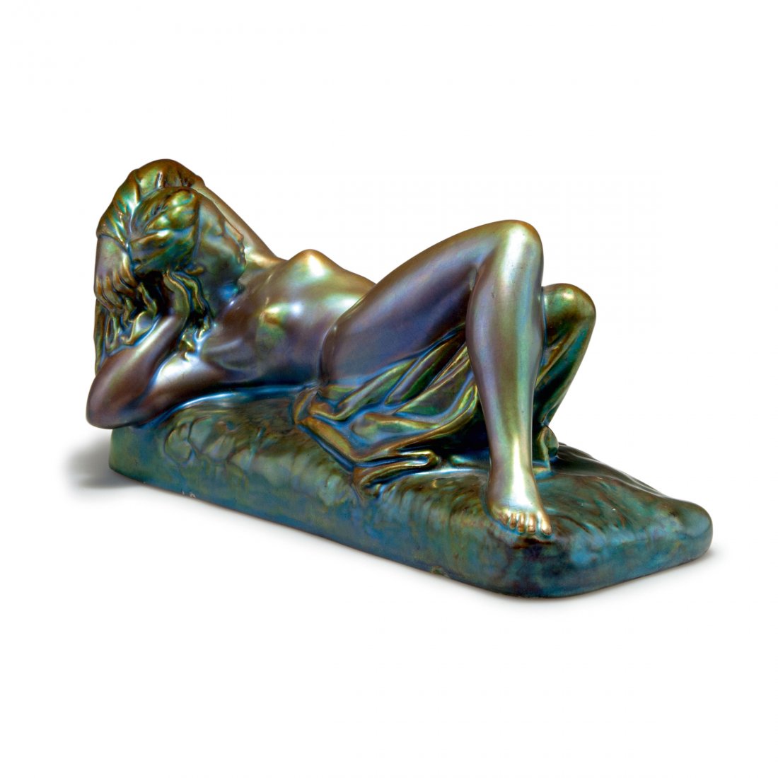 Reclining nude, prior to 1918: Vilmos Zsolnay, Pecs. Reclining nude, priort to 1918. H. 11 cm, 22.1 x 11 cm. Earthenware, eosin glaze, green/golden and wine red. Marked: Seal.