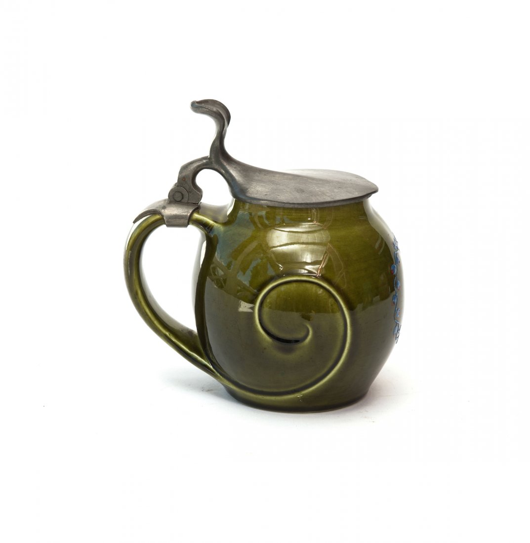 Beerstein, 1900: Richard Riemerschmid. Beerstein, 1900. H. 15.2 cm. Made by Villeroy & Boch, Mettlach for Vereinigte Werkstaetten, Munich. Faience, green glaze, blue enamel, wreath. Pewter lid. Marked: RR VW, O1, II,