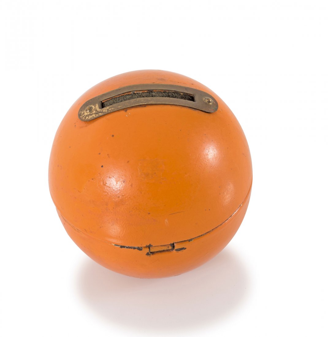Money box, c1929-32: Marianne Brandt. Money box, c1929-32. H. 7.5 cm. Made by Ruppelwerk, Gotha. Sheet brass, painted orange. Marked: Remains of a maker's stamp with star.