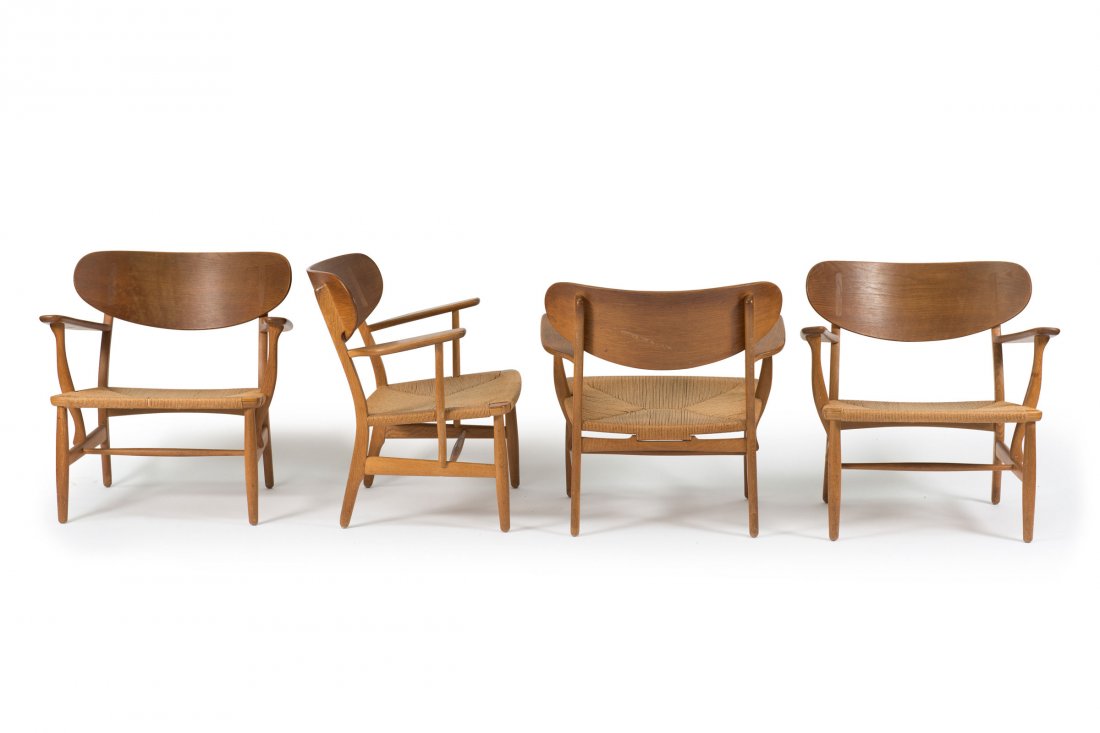 Armchair 'CH 22', 1950: Hans J. Wegner. Four 'CH 22' chairs, 1950. H. 72.5 x 72 x 63 cm. Made by Carl Hansen & Son, Odense. Oak, plywood with oak veneer, paper cords. Marked: (...) BY CARL HANSEN & SON ODENSE DENMARK, DESIGN