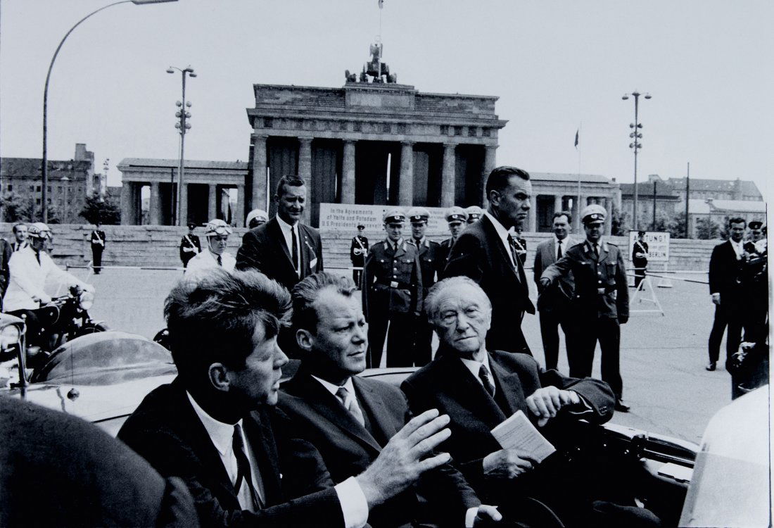 'John F. Kennedy, Willy Brandt, Konrad Adenauer in: Will McBride. 'John F. Kennedy, Willy Brandt, Konrad Adenauer in front of the Brandenburger Tor (a unique recording)', 1973. Gelatine silver print on Baryt paper. 51.0 x 61.0 cm (paper). Signed on the