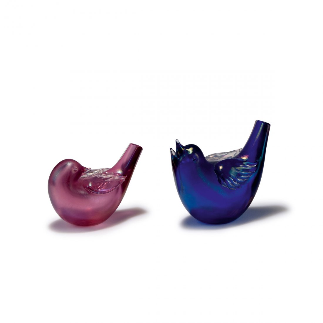 Tyra Lundgren. Two pigeons, c1935. H. 9.2-12 cm. Made: Tyra Lundgren. Two pigeons, c1935. H. 9.2-12 cm. Made by Venini & C. Cased glass, clear and blue resp. pink iridescent. Marked: venini murano ITALIA (acid stamp).