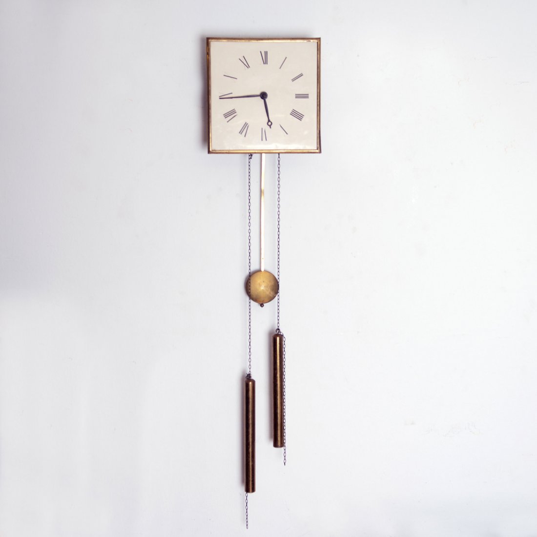 Heinrich Tessenow. Wall clock, 1910. H. 24.7 x 24.7 x: Heinrich Tessenow. Wall clock, 1910. H. 24.7 x 24.7 x 10.8 cm. Made by Deutsche Werkstaetten, Dresden-Hellerau. Wood, vanilla yellow clock face, black roman numerals. Brass frame, pendulum and clock w