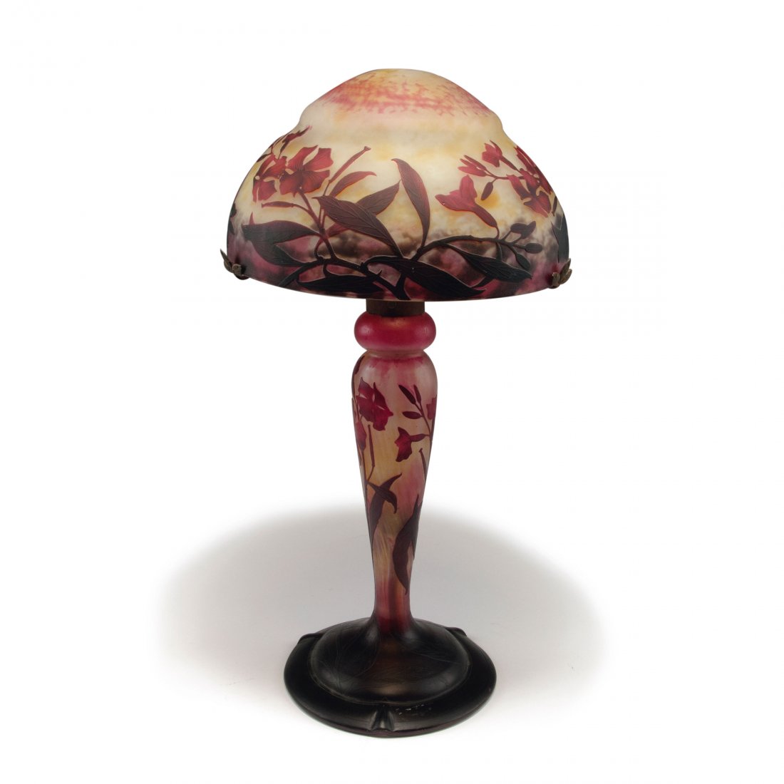 'Laurier rose' table light, 1910-12: Daum Freres, Nancy. 'Laurier rose' table light, 1910-12. H. 15 cm. Clear glass, powder inclusions, orange, yellow and purple, deep red layer. Multiply etched pattern with oleander. Shade signed: DAUM 
