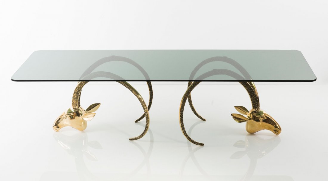 'Ibex head' coffee table, c1970: Leon Francois Chervet; Phyllis Morris (in the style of). 'Ibex head' coffee table, c1970. H. 41 x 60 x 160 cm. Brass, smoke colored glass.