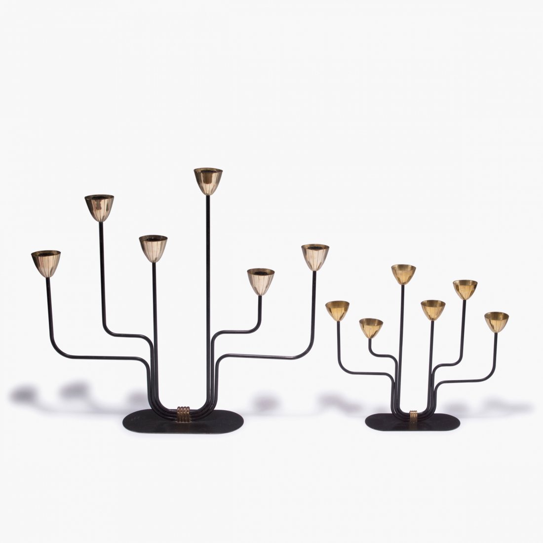 Two candle holders, 1950s: Gunnar Ander. Pair of candlesticks, c1960. H. 26,5-41 cm. Made by Ystad Metall, Ystad. Brass rods, painted black, brass.