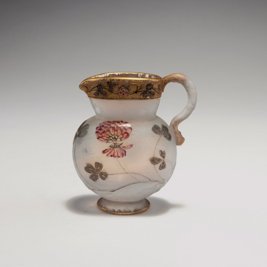 Small 'Trefle' jug, 1895: Daum Freres, Nancy. Small 'Trefles' jug, 1895. H. 9 cm. Cased glass, opal white and clear, etched and enamelled. Clover. Gilding. Signed: Daum Nancy, cross of Lorraine.
