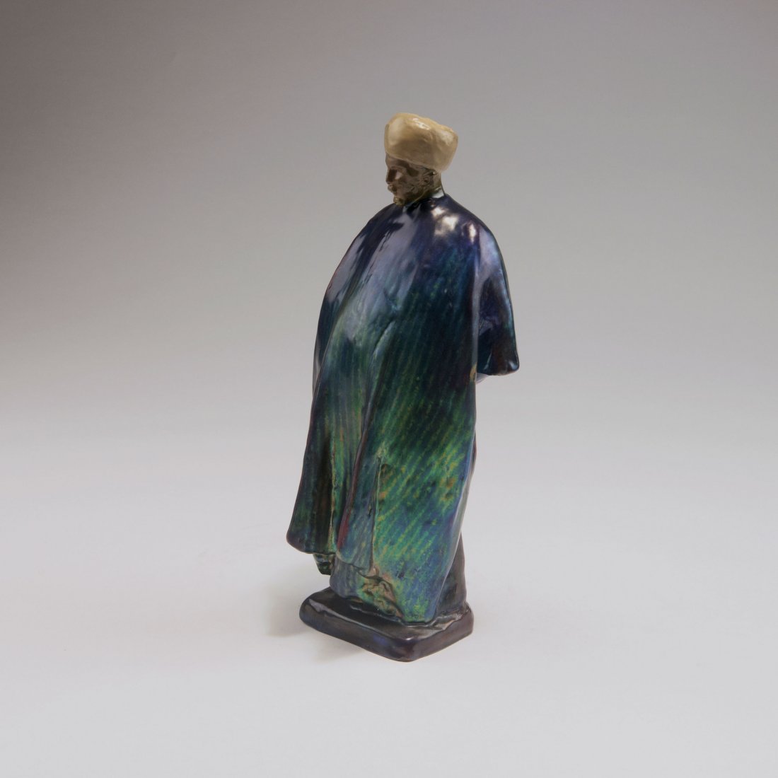 'Imam', past 1920: Vilmos Zsolnay, Pecs. 'Imam', past 1920. H. 23.9 cm. Earthenware, eosin glaze, blue metallic. Back with faint signature. Marked: Maker's mark, ZSOLNAY PECS MADE IN HUNGARY.