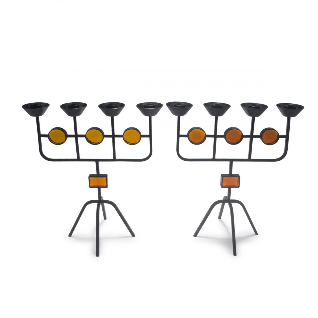Two candlesticks, 1950s: Gunnar Ander. Two candlesticks, 1950s. H. 32.5 cm. Made by Ystad Metall, Ystad. Metal, black patina, amber glass. Marked: Ystad Metall MADE IN SWEDEN.