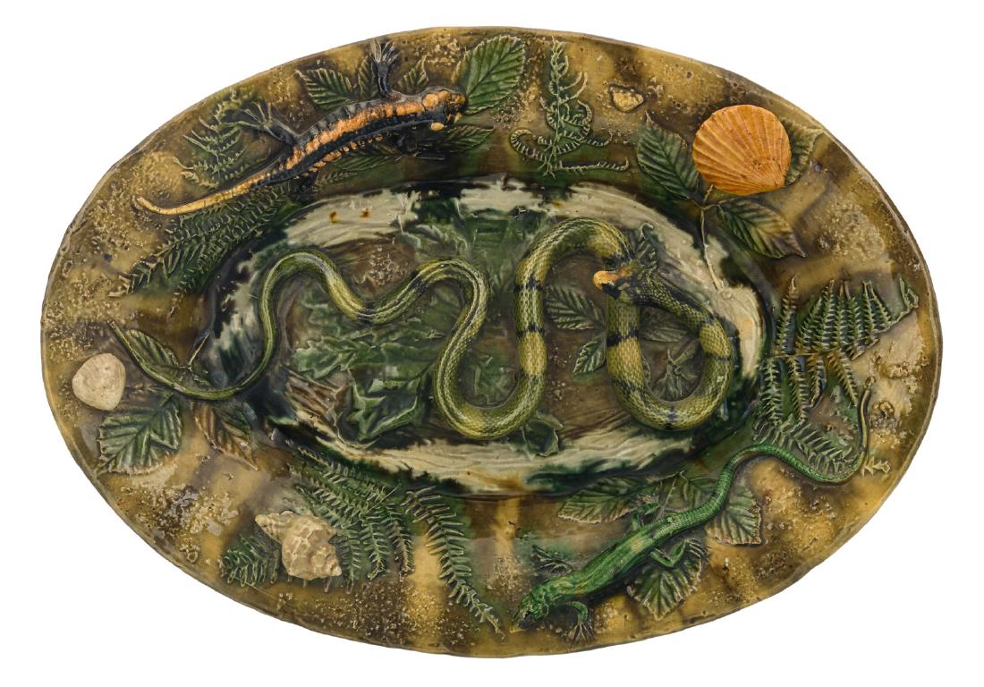 A polychrome and relief decorated earthenware plate in (1 of 3)