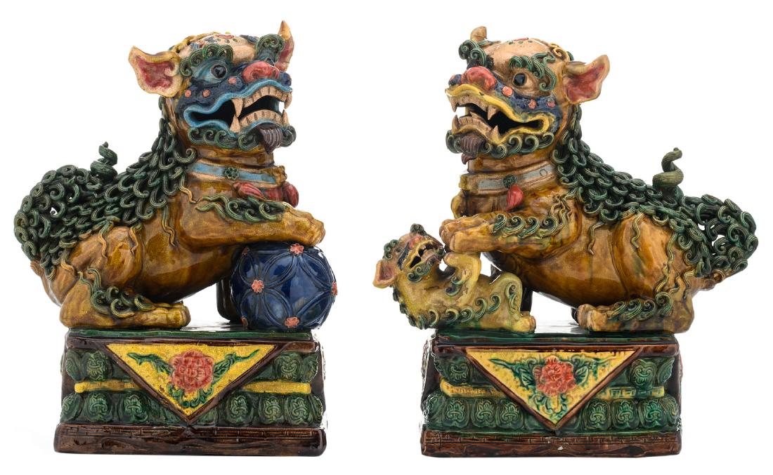 A pair of Japanese polychrome glazed earthenware: A pair of Japanese polychrome glazed earthenware Shishi, H 40 cm