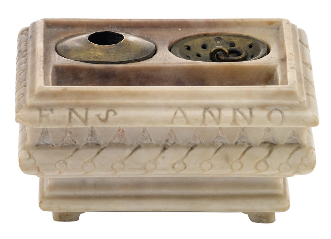 A 17thC alabaster ink set with brass sand sifter and: A 17thC alabaster ink set with brass sand sifter and lead and brass inkwell, with an inscription on the edge 'Suster Josynken Janssens Anno 1645', H 8 - W 15 cm
