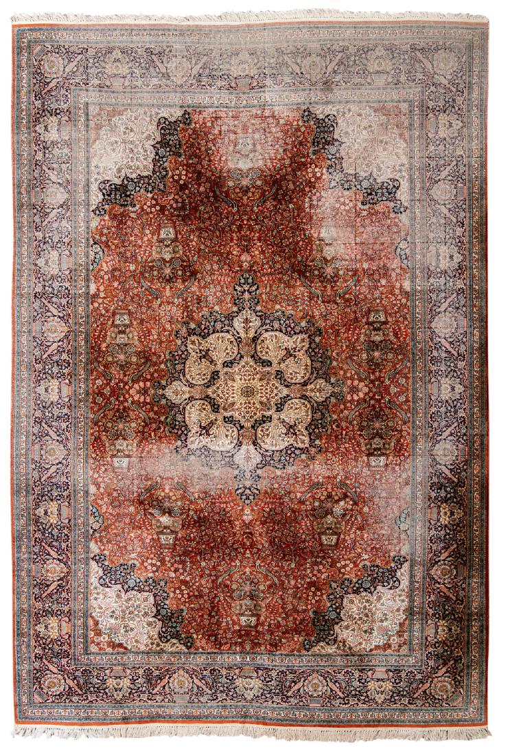 A large and royal Oriental floral decorated silk rug: A large and royal Oriental floral decorated silk rug with birds and flower baskets, with a central medallion, 360 x 561 cm