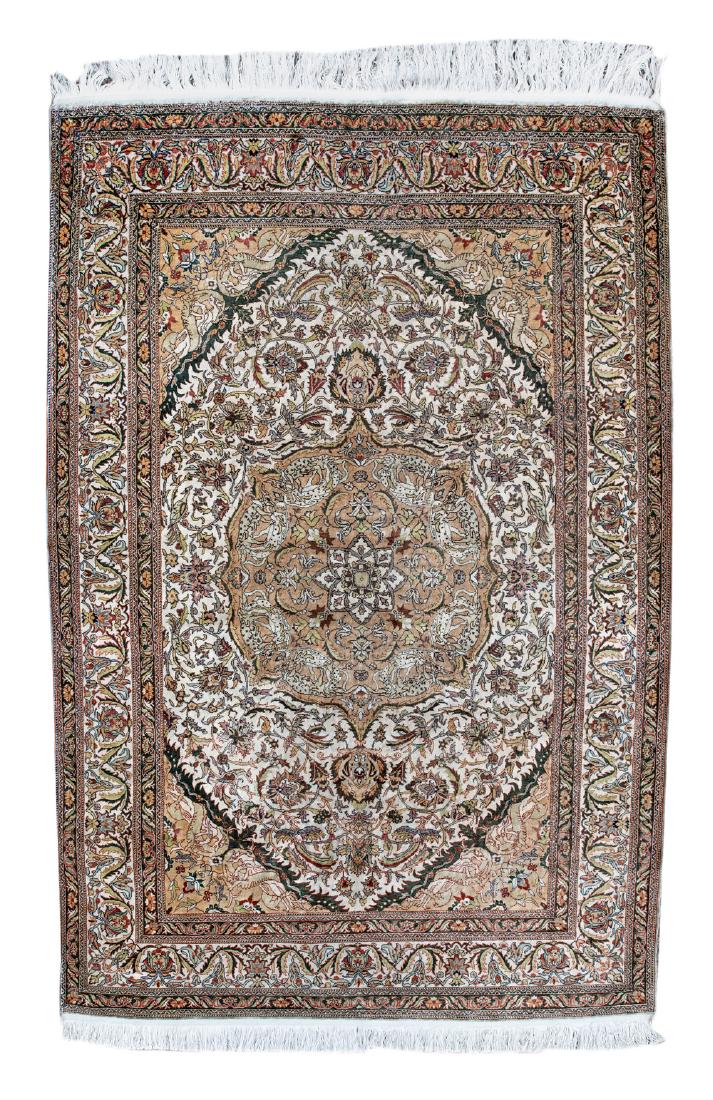 An Oriental floral decorated silk carpet with a central: An Oriental floral decorated silk carpet with a central medallion, 127 x 198 cm