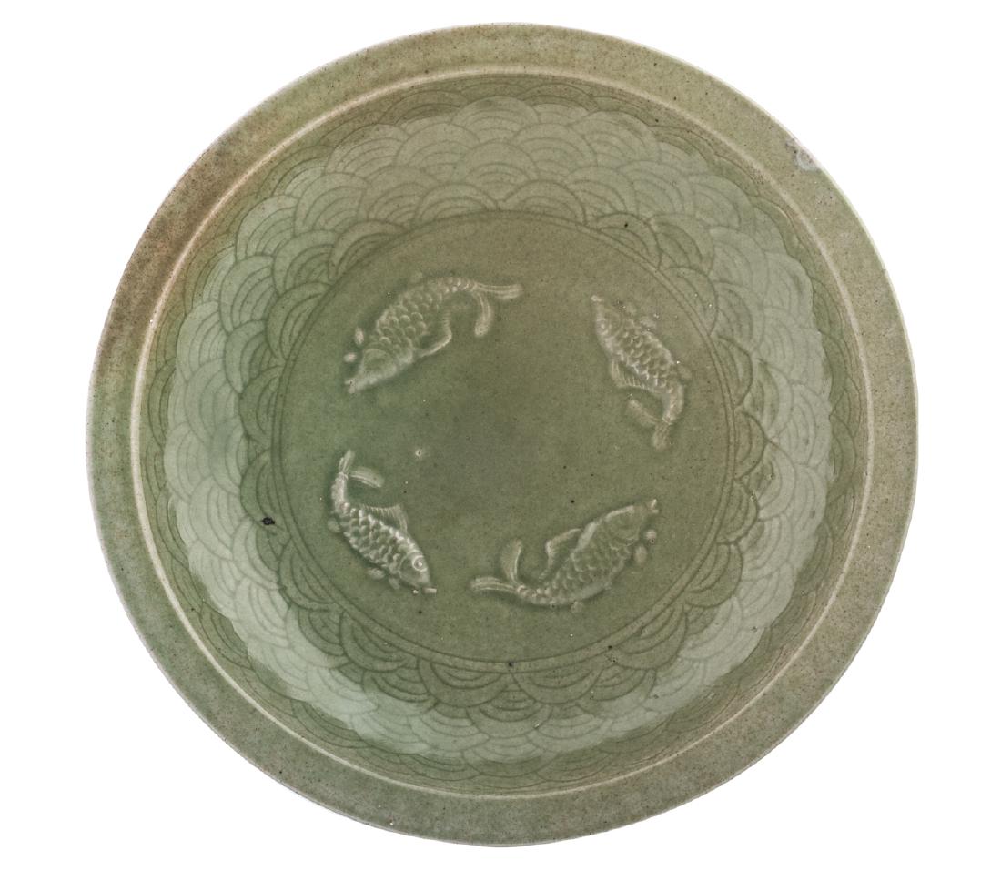 A Chinese celadon stoneware plate with small rim, (1 of 2)