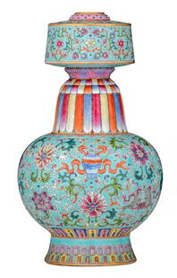 A Chinese turquoise ground famille rose Tibetan style: A Chinese turquoise ground famille rose Tibetan style altar vase, decorated with scrolling lotus and Buddhist symbols, with a Qianlong mark, H 27 cm