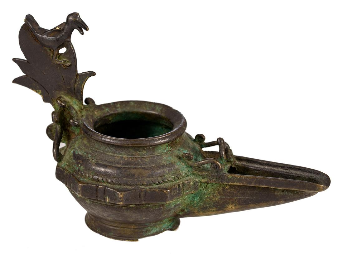 A bronze Khorasan type oil lamp, the grip moulded as a (1 of 6)