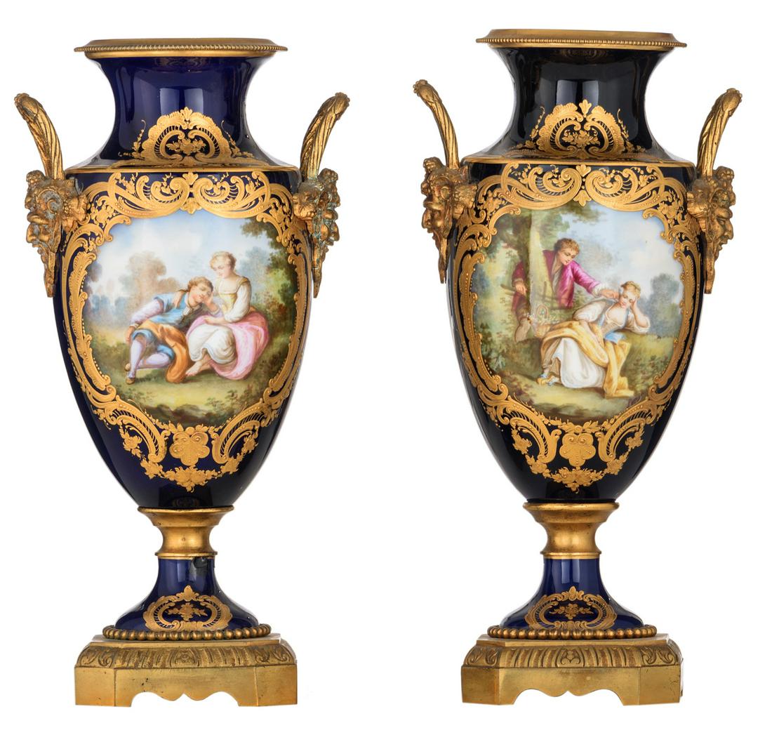 A fine pair of bleu royale ground Sevres vases with: A fine pair of bleu royale ground Sevres vases with gilt bronze mounts, the roundels polychrome decorated with hand painted gallant scenes, signed by Perot, marked Sevres, H 33 cm